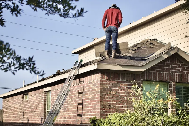 Professional roofer working on a residential roof in Robbins Rest